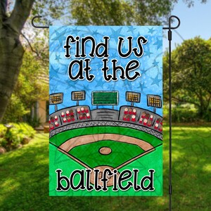 May include: A blue and white garden flag with a baseball field illustration and the text "Find us at the ballfield".