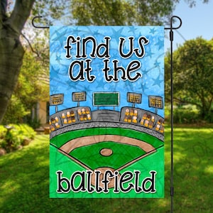 May include: A colorful garden flag with a baseball field illustration and the text "Find us at the ballfield".