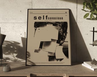 May include: A black and white poster with the text "self conscious" in bold, white letters. The poster features a black and white photo of a person's face partially obscured by beige paper squares.