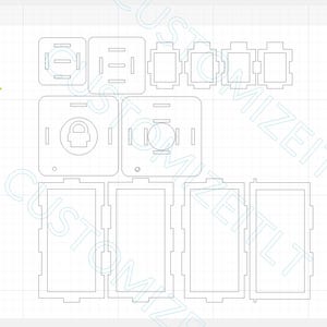 May include: A digital design layout featuring various laser-cut shapes. The design includes rectangular and square components with intricate cut-out details, including circles, rectangles, and a padlock symbol. The shapes are arranged on a grid background, suggesting a template or pattern.