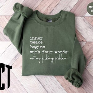 a green sweatshirt with white writing on it