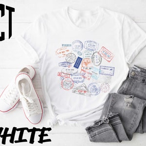 a white t - shirt with a bunch of stamps on it