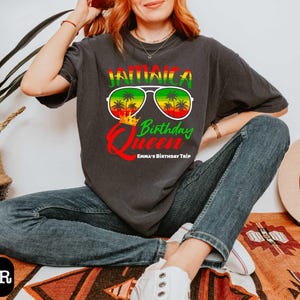 a woman sitting on the floor wearing a t - shirt