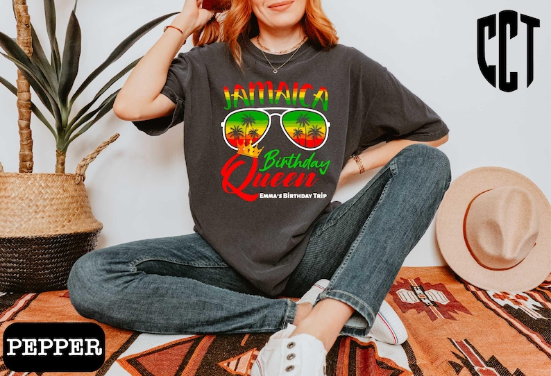 a woman sitting on the floor wearing a t - shirt