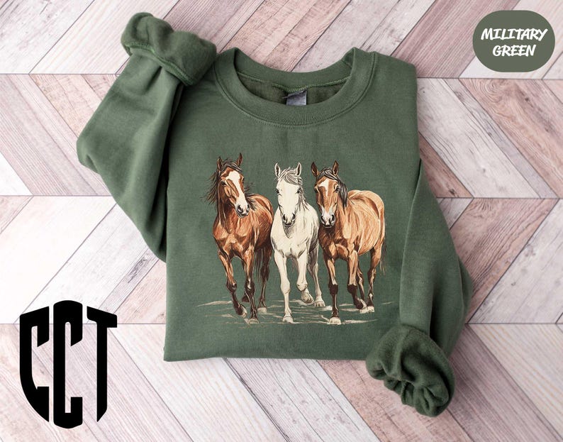 a green sweatshirt with three horses on it
