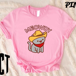 a pink shirt with a cat wearing a cowboy hat