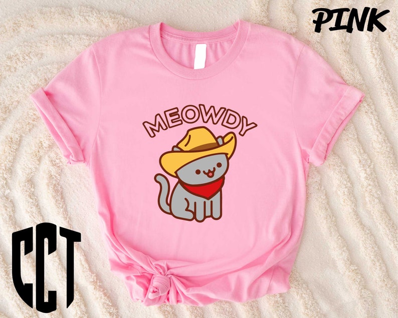 a pink shirt with a cat wearing a cowboy hat