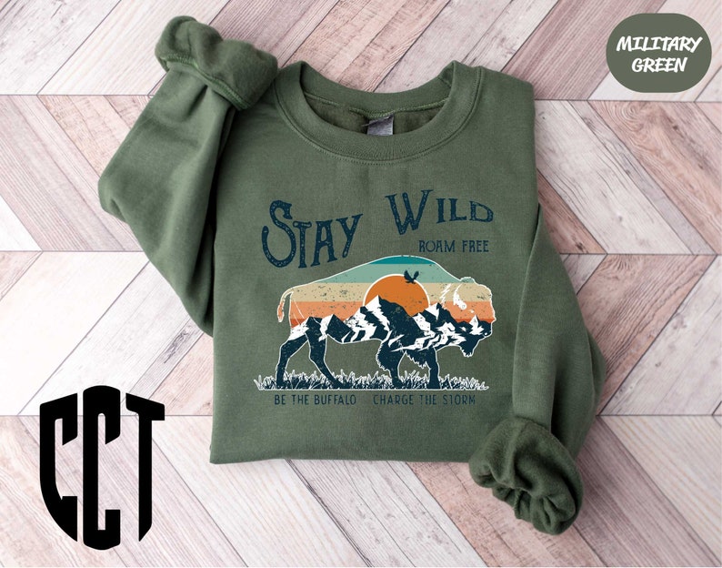 a green sweatshirt with a picture of a bear on it