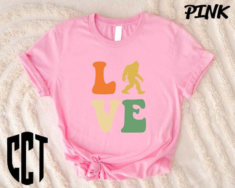 a pink shirt that says love with a bigfoot on it