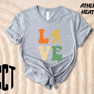 a t - shirt that says love with a bigfoot on it