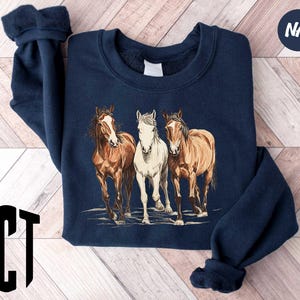 a group of horses standing next to each other on a wooden floor