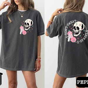 a woman wearing a black shirt with a skull on it
