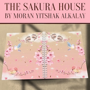 May include: A pink and brown spiral bound notebook with a floral design featuring pink cherry blossoms, gold glitter, and small birds. The cover reads "The Sakura House by Moran Yitshak Alkalay".
