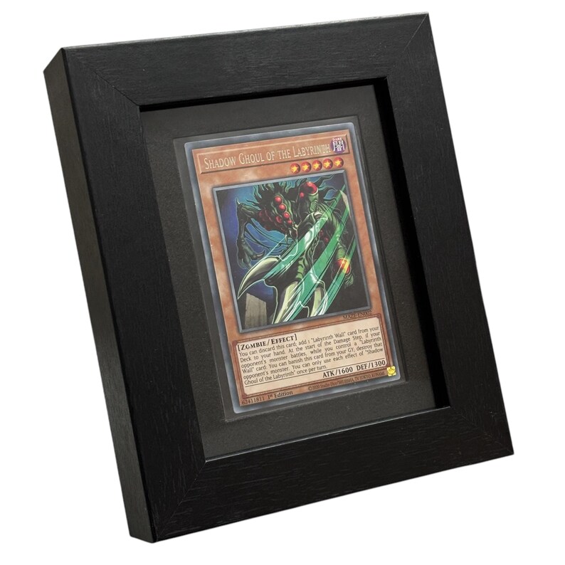 May include: A framed trading card featuring the "Shadow Ghoul of the Labyrinth" with a monster illustration. The card is in a black frame with a black mat. The card's text includes "ZOMBIE/EFFECT" and "ATK/1600 DEF/1300".
