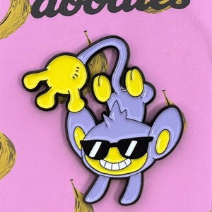 Aipom Enamel Pin – Cool Guy Pokémon-Inspired Pin – Cute Purple Monkey Pin – Anime Fan Gift – Nintendo Collectible