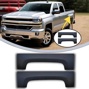 May include: A set of two black plastic wheel well trim pieces for a pickup truck. The trim pieces are designed to protect the wheel wells from damage and dirt.