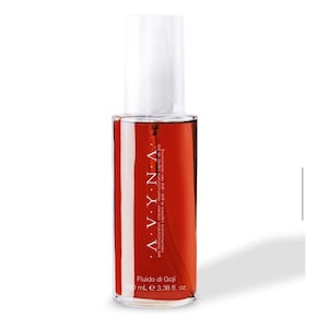 May include: A clear bottle of AVYNA Fluido di Goji hair restructuring product. The bottle contains a reddish-orange liquid and has a white spray nozzle. The label includes text in multiple languages, including "100 mL e 3.38 fl. oz."