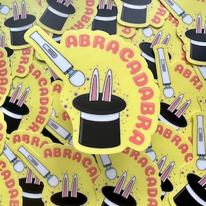 May include: A collection of colorful stickers featuring a black top hat with bunny ears and the text "ABRACADABRA".