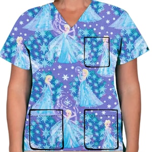 Pode incluir: Um top de trabalho roxo com decote em V e mangas curtas. O top apresenta um padrão repetido de flocos de neve e os personagens do filme Frozen. O top tem três bolsos, dois na parte inferior e um no peito esquerdo.