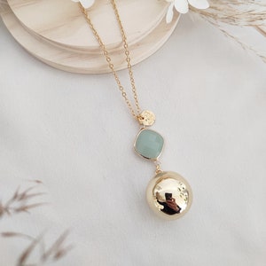 Pregnancy bola with a choice of stones: sea green, orange, or purple.