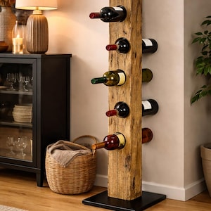May include: A wooden wine rack, holding six bottles of wine, is made from a weathered wooden beam. The rack is mounted on a black metal base. The bottles are displayed horizontally. The rack is approximately 100 cm tall.
