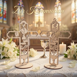 May include: Two wooden crosses with intricate cut-out designs, featuring a child figure, a book, and religious symbols. The crosses are on a table with white flowers and the text "Zur Kommunion" in gold.