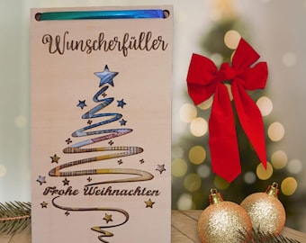 May include: A wooden Christmas card with a cutout of a Christmas tree made of money. The card says "Wunscherschüller" and "Frohe Weihnachten".