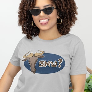 May include: A gray t-shirt with a cartoon wildebeest and the Hebrew text "GNU?" in a blue oval.