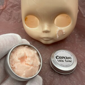 Modeling paste, craft supplies, customizing tools, and a UV lamp for doll face making. Modeling paste is often used to sculpt facial features, while customizing tools can be used to add details like lips or eyeshadow.
