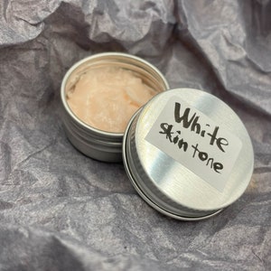 Modeling paste, craft supplies, customizing tools, and a UV lamp for doll face making. Modeling paste is often used to sculpt facial features, while customizing tools can be used to add details like lips or eyeshadow.