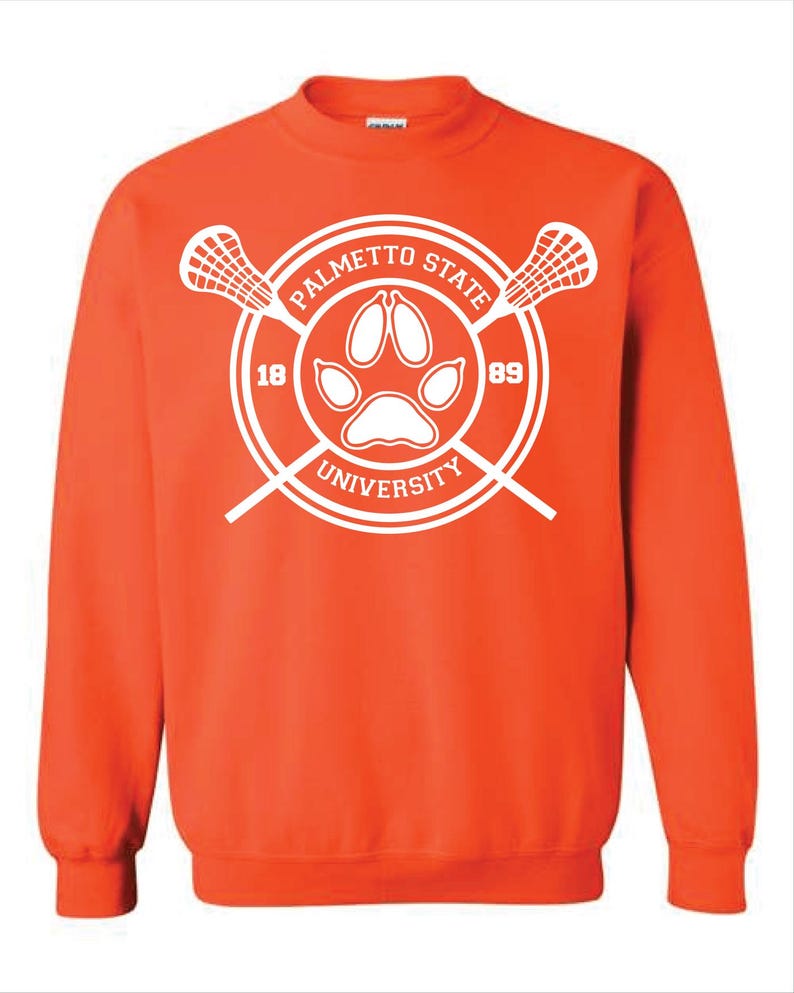 May include: An orange sweatshirt with a white Palmetto State University logo. The logo features a paw print, crossed lacrosse sticks, and the numbers 18 and 89. The text "Palmetto State University" is arched around the paw print.