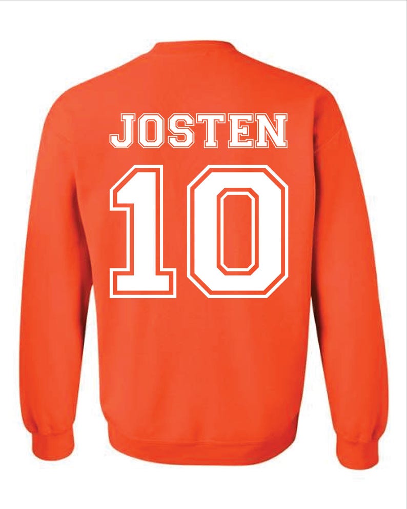May include: An orange sweatshirt with the name "JOSTEN" in white block letters across the upper back and the number "10" in white, outlined block letters below. The sweatshirt has long sleeves and a crew neck.