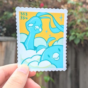 May include: A sticker with a cartoon illustration of two blue creatures with white clouds on a yellow background. The sticker has a postage stamp design with the numbers 333 and 334 in the upper left corner.