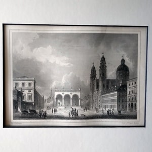 Pode incluir: Gravura arquitetónica a preto e branco que retrata uma praça da cidade europeia com edifícios, arcos e uma catedral. A gravura é emoldurada a preto e com passe-partout branco. Pessoas e carruagens são visíveis.