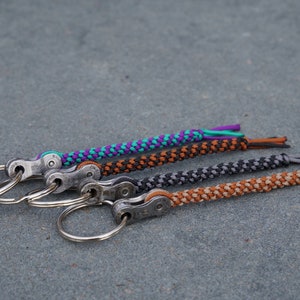 handmade keychain with real chain link from a bicycle chain, pendant with bicycle chain link, bicycle, knotted