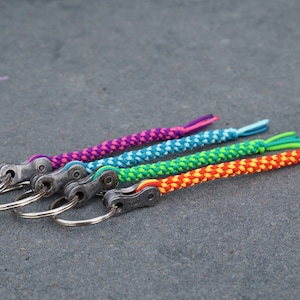 handmade keychain with real chain link from a bicycle chain, pendant with bicycle chain link, bicycle, knotted