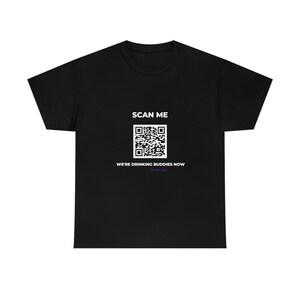 May include: Black t-shirt with a white QR code and the text "SCAN ME" and "WE'RE DRINKING BUDDIES NOW" in white. The text "GOOD LIFE" is in purple below the QR code.