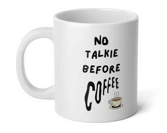 May include: White ceramic coffee mug with black text that reads "No Talkie Before Coffee" and a small illustration of a steaming cup of coffee.