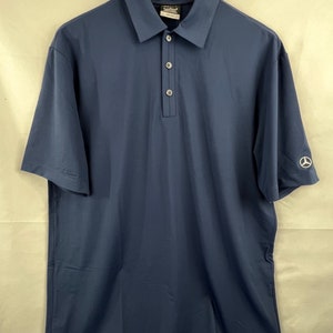 May include: A navy blue short-sleeved polo shirt with a button-up collar and a small logo on the right sleeve.