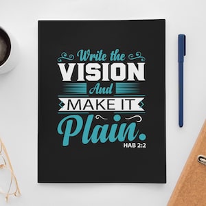May include: Black notebook with the text "Write the Vision and Make it Plain. HAB 2:2" in white and blue lettering.