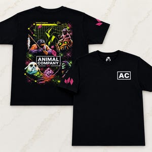 May include: A black short-sleeve t-shirt featuring a graphic print on the back and front. The back displays a colorful digital scene with creatures, the text ANIMAL COMPANY VR, and pink crystals. The front features a white box with the letters AC.
