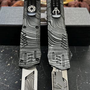 automatic tool without blade. can accept razor blades. beskar engraved design. aluminum alloy.