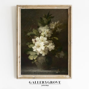 May include: A framed painting of a still life featuring a vase of white flowers with green leaves against a dark background.