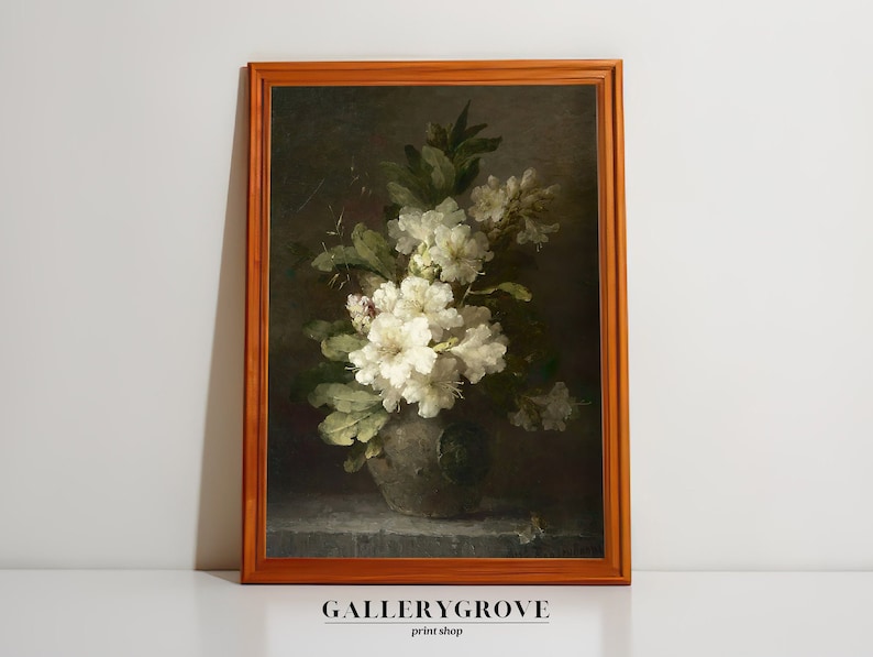 May include: A framed painting depicting a still life with a bouquet of white flowers in a dark green vase. The flowers are arranged in a relaxed, natural way, and the vase features a floral design. The background is a dark, muted colour, and the painting is framed in a plain, brown frame.