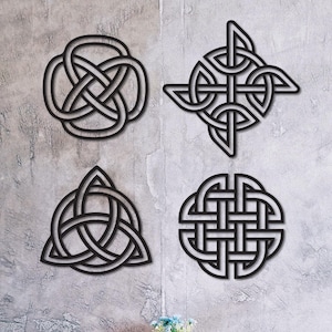 May include: Four black painted Celtic knot wall art pieces in various designs are displayed on a textured gray wall. Below, a small round wooden table and two matching stools with black metal legs are visible. The text "Black Painted" is at the bottom.