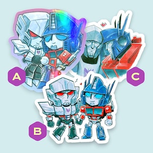 May include: Three stickers with cartoon illustrations of Transformers characters. The stickers show Optimus Prime and Megatron in different poses, with a holographic effect on one. The characters are in blue, red, silver, and black.