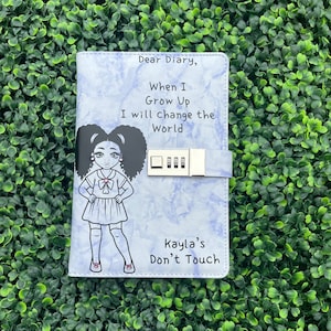 May include: A blue diary with a lock and a drawing of a girl with the text "Dear Diary, When I Grow Up I will change the World" and "Kayla's Don't Touch".