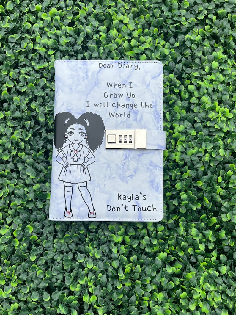 May include: A blue diary with a lock and a drawing of a girl with the text "Dear Diary, When I Grow Up I will change the World" and "Kayla's Don't Touch".