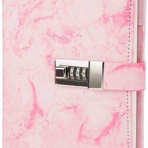 May include: Pink marble-patterned journal with a silver combination lock. The journal has a white interior and the word "Pink" is printed on the bottom right corner.