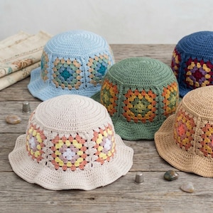 May include: A white ceramic mug with a black handle and the text "But First, Coffee" in a bold, black font. The mug is set against a blurred background, suggesting a cozy setting.